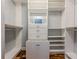 Spacious walk-in closet featuring custom built-ins, drawers, shelving, and wood floors at 2921 Lenox Ne Rd # 113, Atlanta, GA 30324