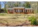 Charming brick home with a covered front porch and classic white trim and a well-manicured front yard at 6339 Cornelia Dr, Douglasville, GA 30134