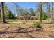 Traditional brick home featuring a covered entryway, symmetrical design, and a spacious, tree-lined front yard at 6339 Cornelia Dr, Douglasville, GA 30134