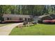 Charming single-story home with well-maintained lawn and colorful landscaping at 1727 Rivermist Sw Dr, Lilburn, GA 30047
