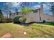 View of cozy backyard with wooden privacy fence, green grass, and mature trees with landscaping at 1124 Country Ct, Lawrenceville, GA 30044