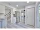 Kitchen boasts stainless appliances, white cabinetry, and wood-look flooring at 1124 Country Ct, Lawrenceville, GA 30044