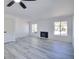 Bright living room featuring wood-look flooring, a ceiling fan, and a fireplace at 1124 Country Ct, Lawrenceville, GA 30044