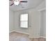 Bright bedroom with light gray walls, wood-look flooring, ceiling fan, and a window with blinds at 2620 Sardis Chase Court, Buford, GA 30519