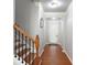 Inviting entryway with hardwood floors, neutral paint, and decorative archway leading to the front door at 2620 Sardis Chase Court, Buford, GA 30519