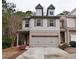 Two-story home with two car garage, brick accents and gable windows at 2620 Sardis Chase Court, Buford, GA 30519