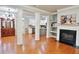 Bright living room with hardwood floors, fireplace, and view of kitchen at 2620 Sardis Chase Court, Buford, GA 30519