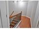 Carpeted staircase with a wrought iron banister and white risers leads to the upper level at 2620 Sardis Chase Court, Buford, GA 30519
