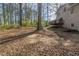 View of the home's backyard featuring mature trees, and a wooden deck at 3637 Windmill Rd, Ellenwood, GA 30294
