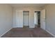 Bedroom showcasing closet, neutral walls, and transition to another room at 3637 Windmill Rd, Ellenwood, GA 30294