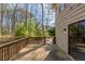Spacious wooden deck with railings provides backyard views at 3637 Windmill Rd, Ellenwood, GA 30294