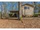 Charming single-story home with a covered porch and mature trees surrounding the property at 3637 Windmill Rd, Ellenwood, GA 30294