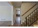 Hallway featuring hardwood floors, stairs, and neutral paint, providing a welcoming transition between spaces at 3637 Windmill Rd, Ellenwood, GA 30294