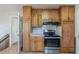 Traditional kitchen featuring wooden cabinets, stainless steel appliances, and laminate countertops at 3637 Windmill Rd, Ellenwood, GA 30294