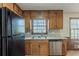 Practical kitchen with stainless steel dishwasher, window view, and plenty of cabinet space at 3637 Windmill Rd, Ellenwood, GA 30294