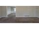 Neutral living area with wall to wall carpeting transitions to the dining room at 3637 Windmill Rd, Ellenwood, GA 30294