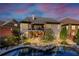Beautiful backyard featuring a stone pool, lush landscaping, and an upper-level deck with outdoor seating at 4916 Locklear Way, Marietta, GA 30066