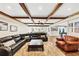 Finished basement with exposed beams, large couches, wood-look flooring, and neutral colors at 4916 Locklear Way, Marietta, GA 30066