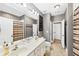 Bathroom with double vanity, neutral colors, marble floors, shower with curtain, and a connecting door at 4916 Locklear Way, Marietta, GA 30066