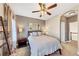 Warm bedroom with a ladder, ceiling fan, cozy lamps, and a neutral color palette at 4916 Locklear Way, Marietta, GA 30066