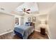 Charming bedroom with a tray ceiling, ceiling fan and luxury vinyl flooring at 4916 Locklear Way, Marietta, GA 30066