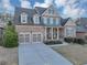Charming two-story brick home featuring a welcoming front porch and a well-manicured lawn at 4916 Locklear Way, Marietta, GA 30066