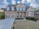 Charming two-story brick home featuring a welcoming front porch and a well-manicured lawn at 4916 Locklear Way, Marietta, GA 30066