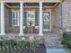 Inviting front porch with stone accents, rocking chairs, and manicured landscaping at 4916 Locklear Way, Marietta, GA 30066