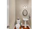Traditional half bathroom with a pedestal sink, oval mirror and hardwood floors at 4916 Locklear Way, Marietta, GA 30066