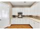 Modern kitchen with stainless steel microwave and gas range nestled amongst clean white cabinetry at 4916 Locklear Way, Marietta, GA 30066