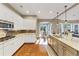 Bright eat-in kitchen features white cabinets, granite countertops, stainless steel appliances, and hardwood floors at 4916 Locklear Way, Marietta, GA 30066
