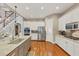 Open kitchen boasts stainless appliances, a large island with granite counters, and easy access to the staircase at 4916 Locklear Way, Marietta, GA 30066
