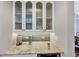 The kitchen features sleek glass-paneled cabinets, ample counter space, and modern appliances at 4916 Locklear Way, Marietta, GA 30066
