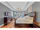 Spacious main bedroom boasts a decorative ceiling, hardwood floors, and plenty of natural light at 4916 Locklear Way, Marietta, GA 30066
