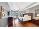 Spacious main bedroom with a tray ceiling, hardwood floors, and large windows for natural light at 4916 Locklear Way, Marietta, GA 30066