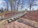 Backyard patio with brick detail and landscaped slope with stairs at 5180 Sterling Trace Nw Ct, Lilburn, GA 30047