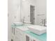 Bright bathroom featuring a double sink vanity with square vessel sinks and light countertops at 5180 Sterling Trace Nw Ct, Lilburn, GA 30047