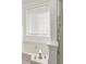 A close-up of a bright white bathroom with a bathtub, tiled walls, and a glass-enclosed shower at 5180 Sterling Trace Nw Ct, Lilburn, GA 30047