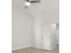 An empty room with light colored walls and floors has a ceiling fan and is staged to show size at 5180 Sterling Trace Nw Ct, Lilburn, GA 30047