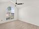 Empty staged room with light colored floors and arched windows provides a great view of the outdoors at 5180 Sterling Trace Nw Ct, Lilburn, GA 30047
