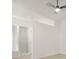 An empty room with light colored walls and floors has a ceiling fan and is staged to show size at 5180 Sterling Trace Nw Ct, Lilburn, GA 30047
