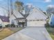Charming one-story home featuring manicured landscaping, attached garage, and a welcoming front porch at 5180 Sterling Trace Nw Ct, Lilburn, GA 30047