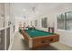 Spacious game room with a pool table and natural light from multiple windows at 5180 Sterling Trace Nw Ct, Lilburn, GA 30047