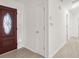 Hallway featuring wood-look flooring, closet doors, and a view of the home's entry at 5180 Sterling Trace Nw Ct, Lilburn, GA 30047