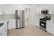 Modern kitchen boasts stainless steel appliances, bright white cabinets, and sleek countertops at 5180 Sterling Trace Nw Ct, Lilburn, GA 30047