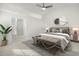 Bright main bedroom featuring a ceiling fan, modern decor, and an attached bathroom for added convenience at 5180 Sterling Trace Nw Ct, Lilburn, GA 30047