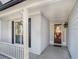 Inviting front porch with white brick accent, leading to the main entrance with glass door at 5180 Sterling Trace Nw Ct, Lilburn, GA 30047