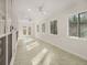 Bright sun room with tile floor, multiple windows and ceiling fans at 5180 Sterling Trace Nw Ct, Lilburn, GA 30047