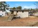 A view of the back of the house with a deck and steps leading to the yard at 6660 Hidden Brook Trl, Atlanta, GA 30349