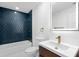 Modern bathroom with navy tiled shower, LED mirror, and vanity at 6660 Hidden Brook Trl, Atlanta, GA 30349